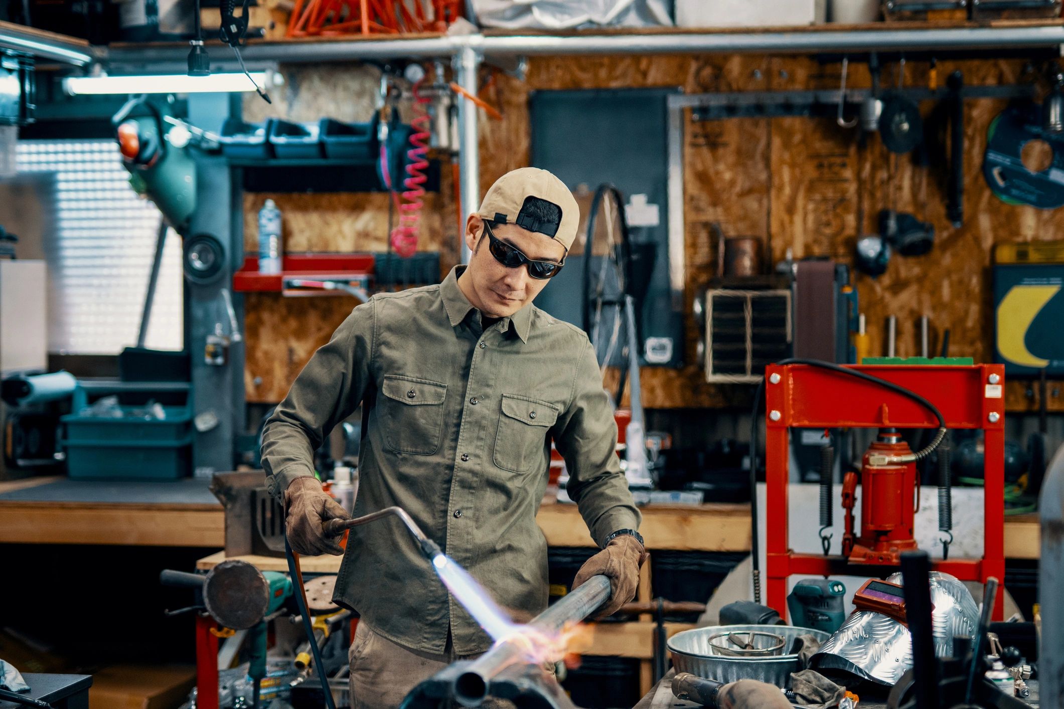 Metalworker shaping heated metal in a workshop