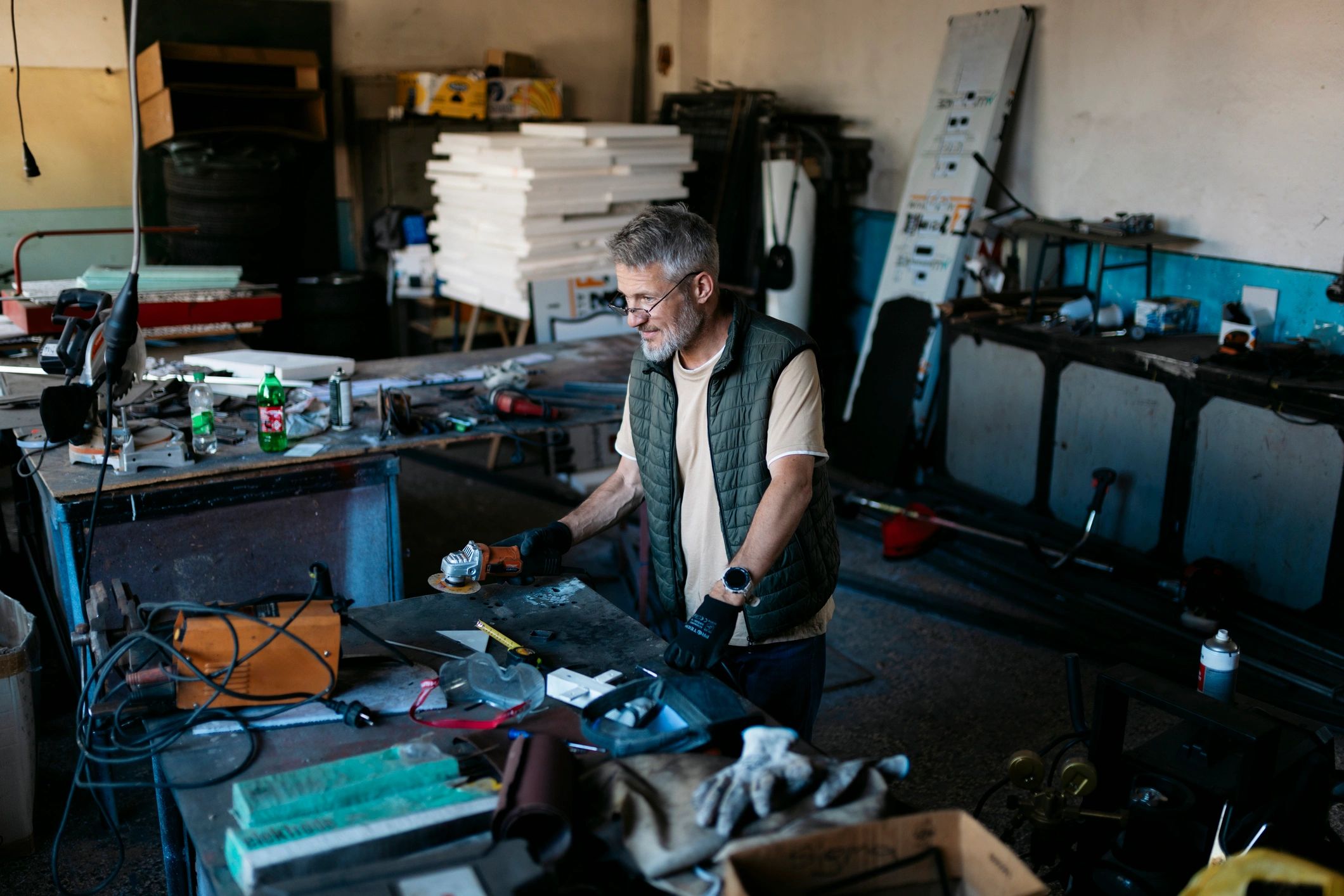 Workshop artisan reviewing a forged piece