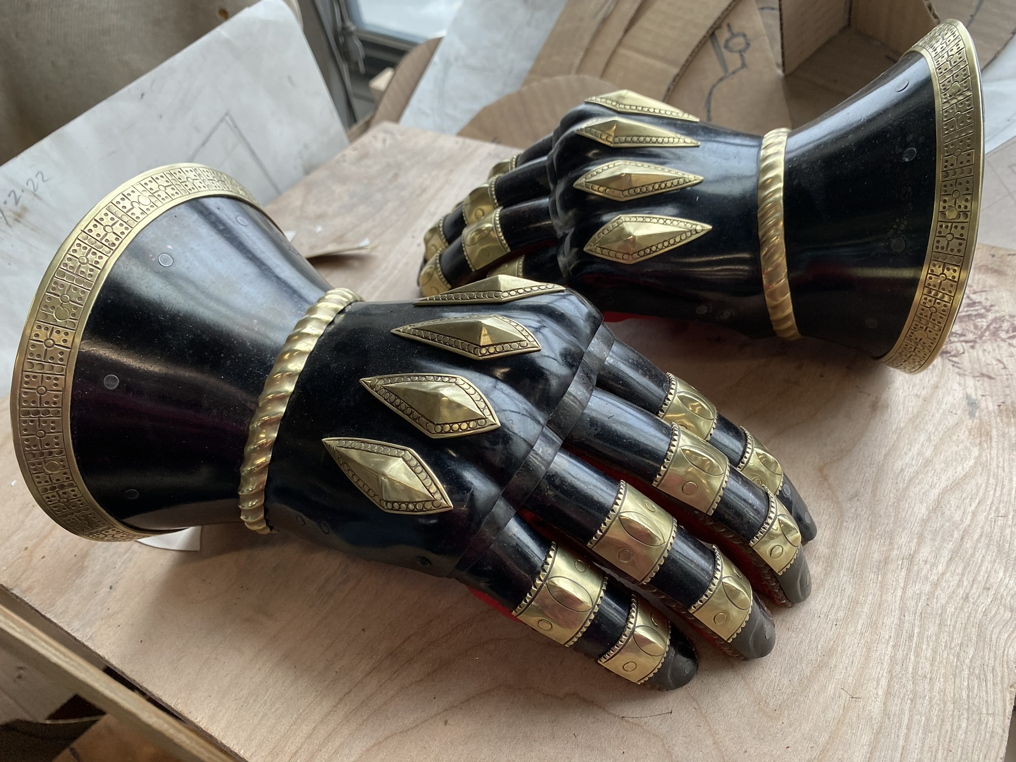 Pair of black and brass armored gauntlets from a previous custom order